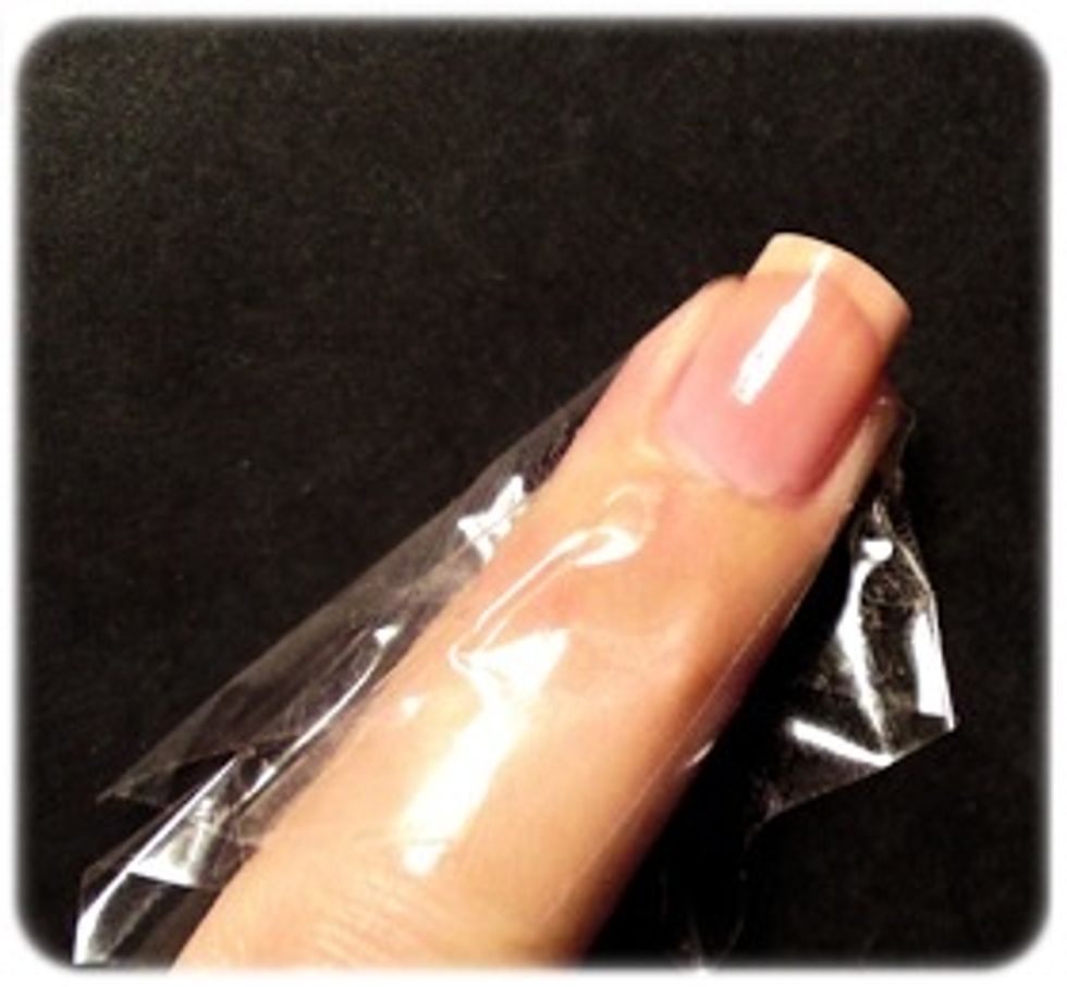 Step 2: Take scotch tape and wrap around the top of the nail base & on the sides to prevent excess polish from getting on the skin. Plus the clean-up process is much easier after you're done!