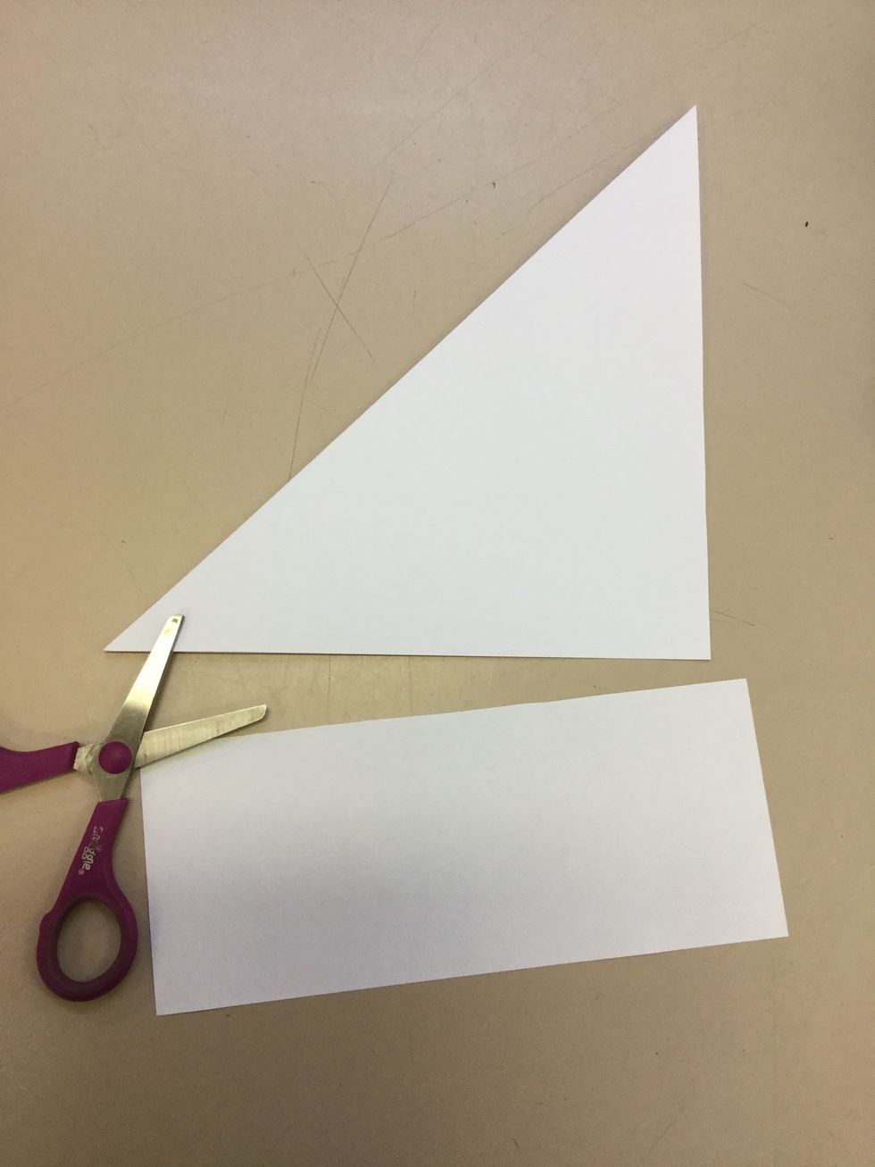 Step 2: Use your scissors and cut off the rectangle at the bottom of the folded triangle.