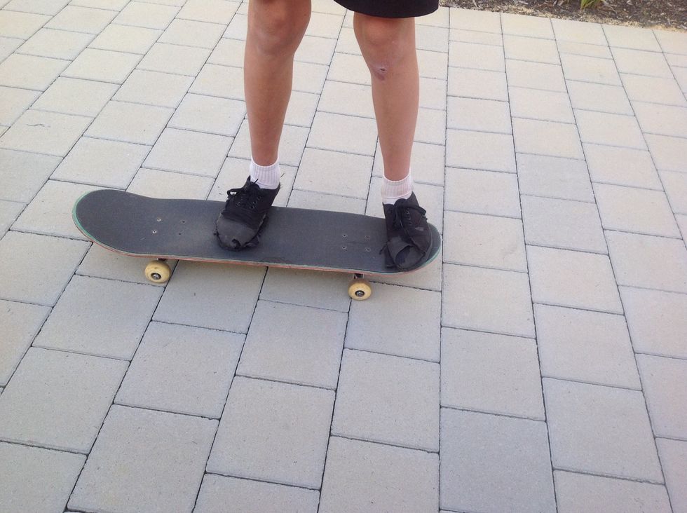 Step 2. Your feet positioning is very important. You want to have your back on the tail and your front foot somewhere in the middle of the board.(Make sure though you feel in a comfortable position)