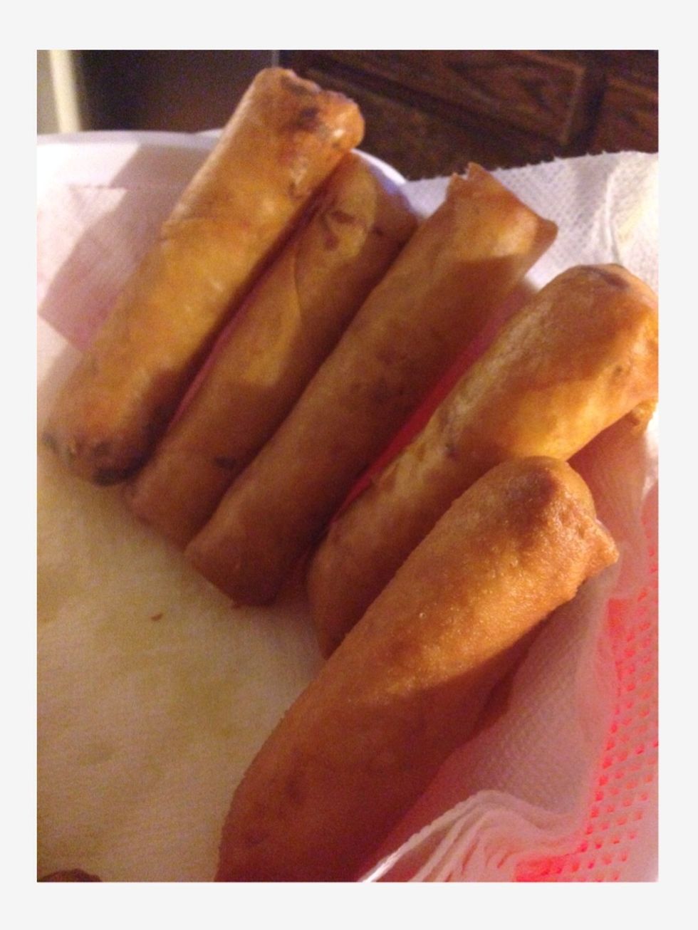 Step 20: After they are golden brown, take them out and put them on paper towels in a bowl. This will help absorb and strain the oil.