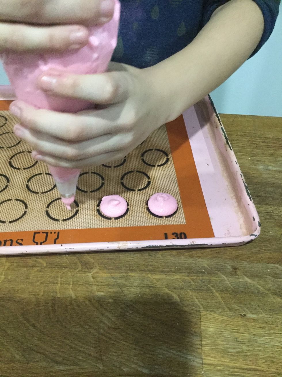 Step 24: It will spread out a bit as it settles. Pull the piping tip off without pulling up, or you will get a tail on your macarons.