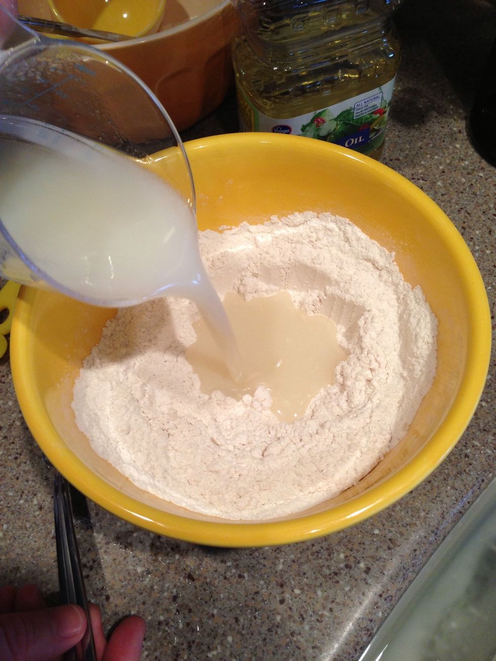 Step 3: Form a well in the flour mixture and pour in the oil mixture.