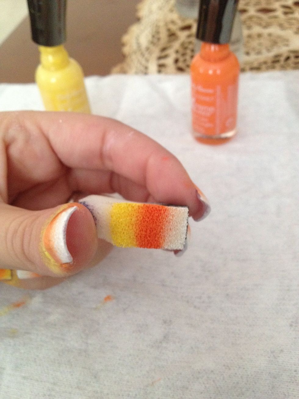 Step 3: Lightly wet sponge in water and paint pattern above yellow, orange and white nail polish