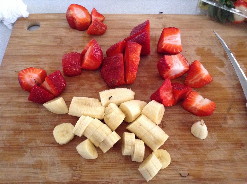 Step 3. Now get your chopping board and knife and start cutting your\u00a0 bananas in 2cm in with and your strawberries into 4 equal parts.