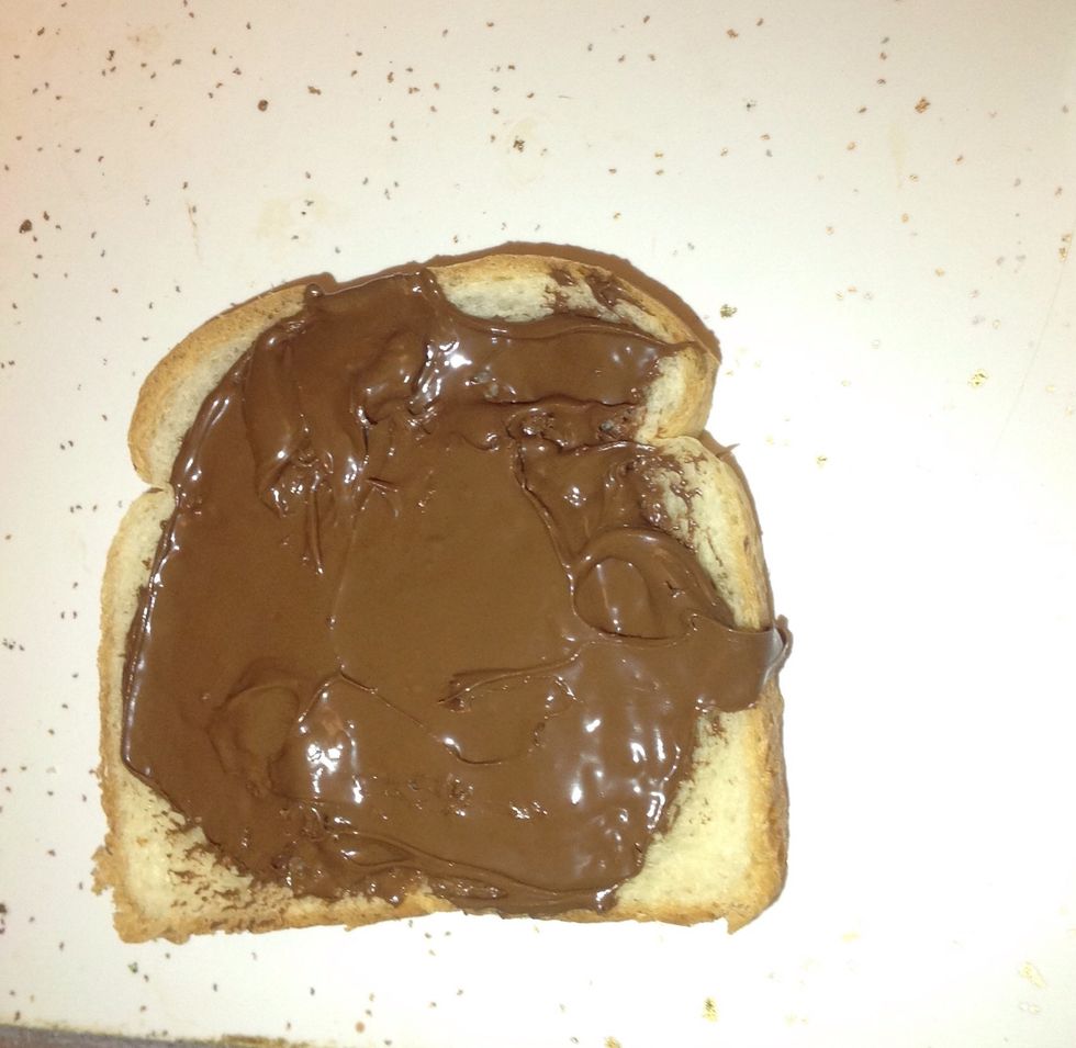 Step 3: spread your Nutella on one side of one single slice of bread (as much as you delight)