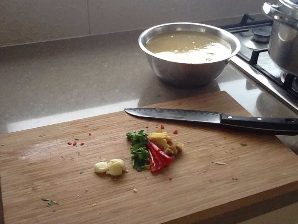 Step 3: take a large saucepan add your chicken stock, add chunks of chilli, coriander root, garlic and ginger. Also add tamari soy and fish sauce to taste