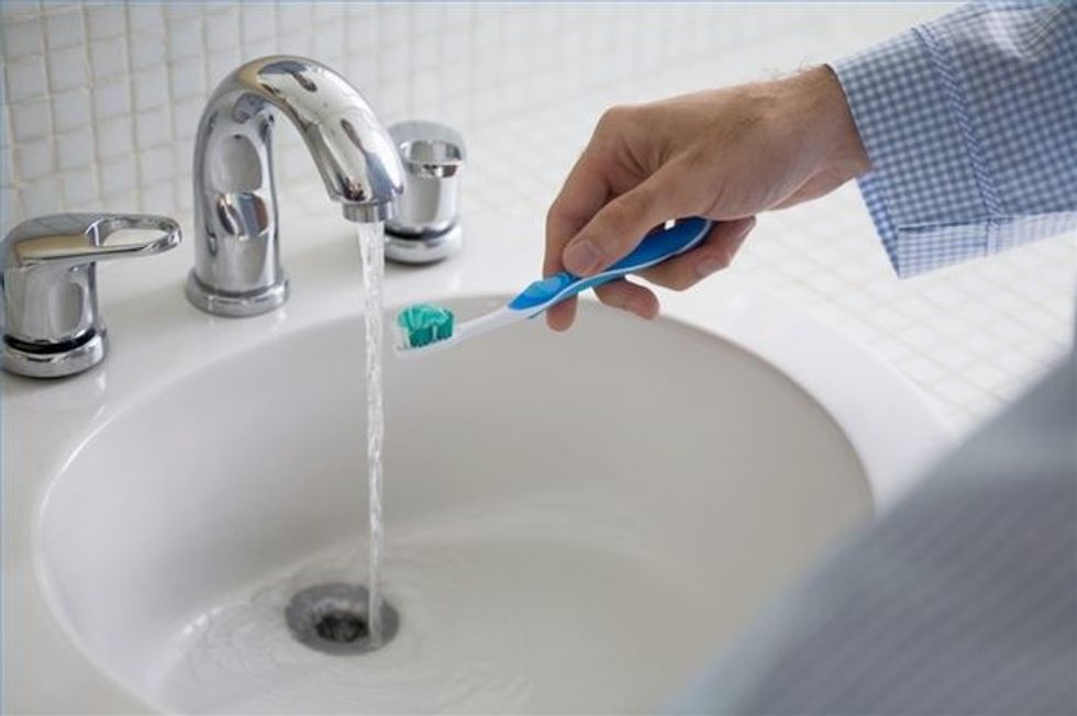 step.3:then take your toothbrush and put it under the tap to wash.