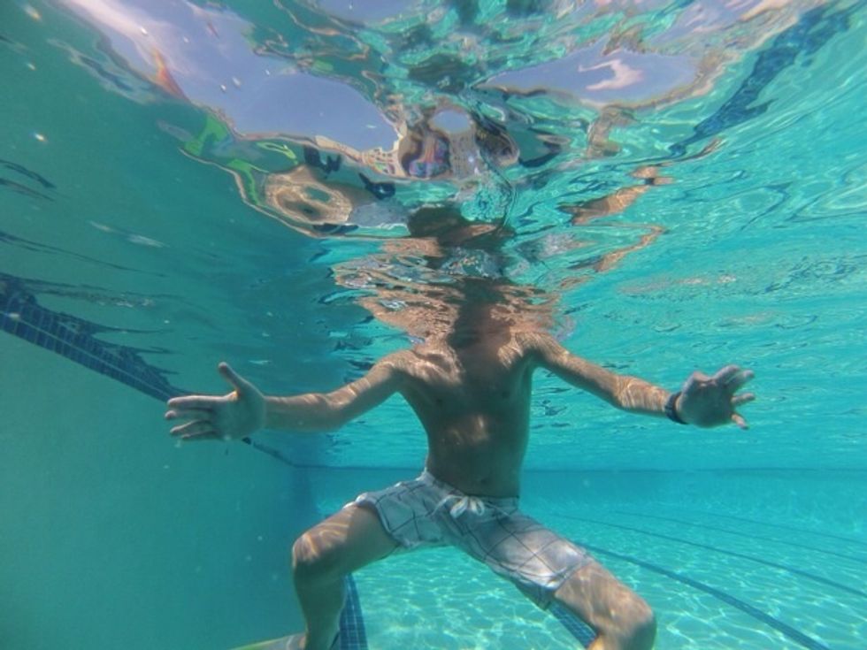 Step 3: Tread water in 5 ft deep water near the wall of the pool. When you tread water your legs should move in a circle and your arms are pushing water away in a constant motion (Eggbeater).