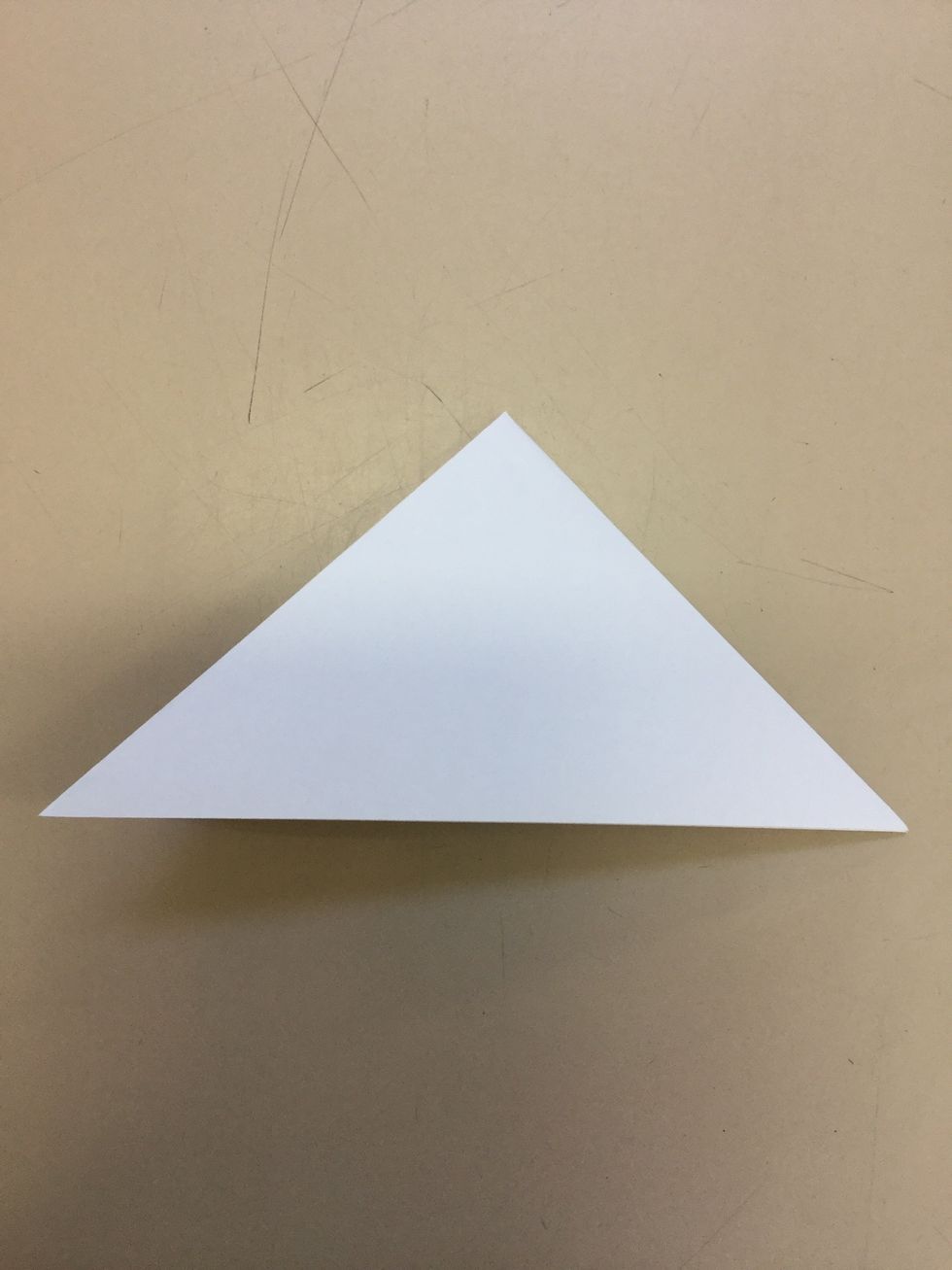 Step 3: Use your hands and grab one of the longer ends of the big triangle and fold to make a smaller triangle.