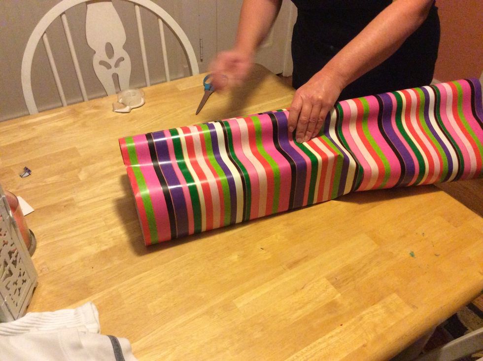 Step 3: Wrap the other half of the wrapping paper around the present.