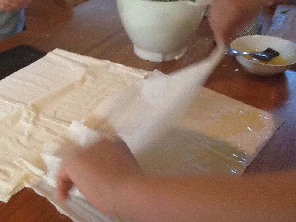 Step 3e) fold both of the sheets in half length way.