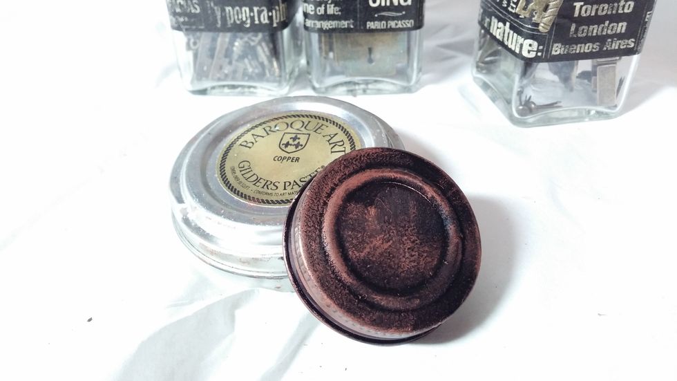 Step 4: A bit of gilders paste brings out the texture of the sealant and the ridges on the lid to add patina and age.