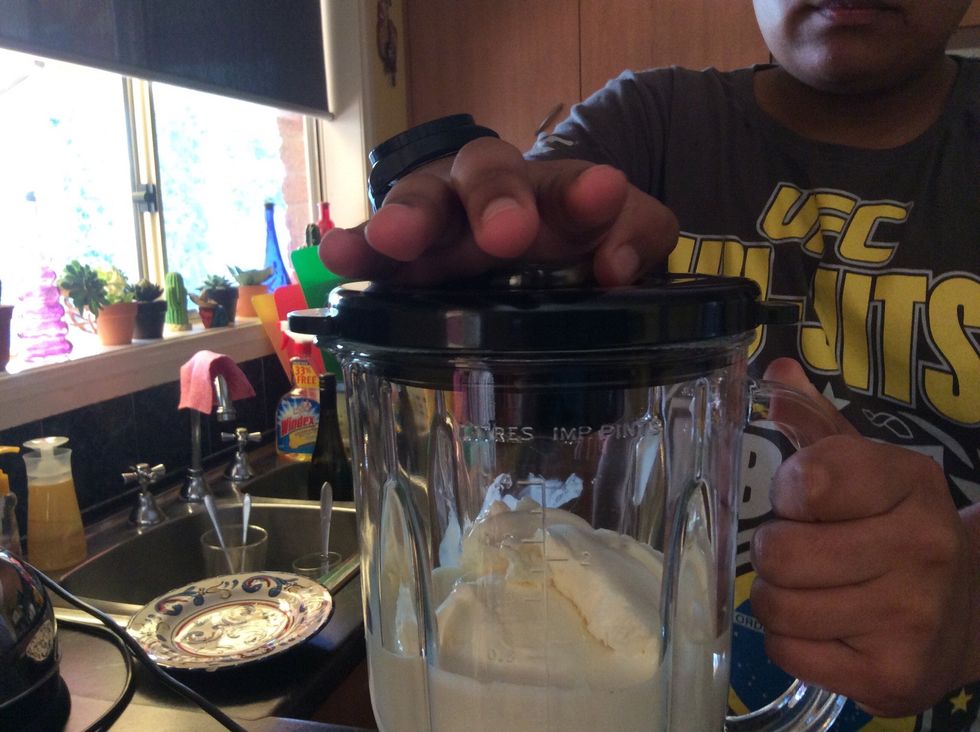 Step 4: After you place 4 scoops of vanilla ice cream, then place the lid on and place it on top of the blender. Be careful if you don't put the lid on the blender firmly it will spread everywhere.