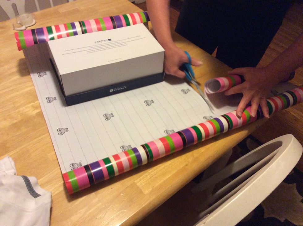 Step 4: Cut the wrapping paper so that there won't be a lot of paper on the sides of the present.