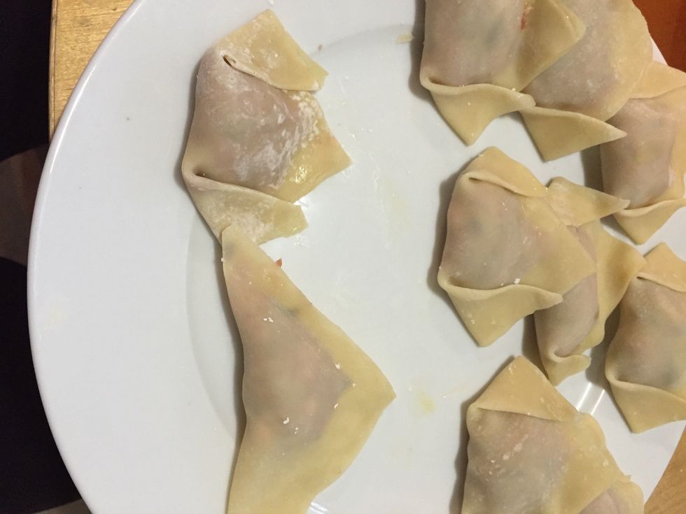 Step 4: fold the other side. You can also leave it as triangle if u want too. To Cook the wonton: boiled water in pot and placed the wonton in it. You could also freeze the leftover uncooked wonton.