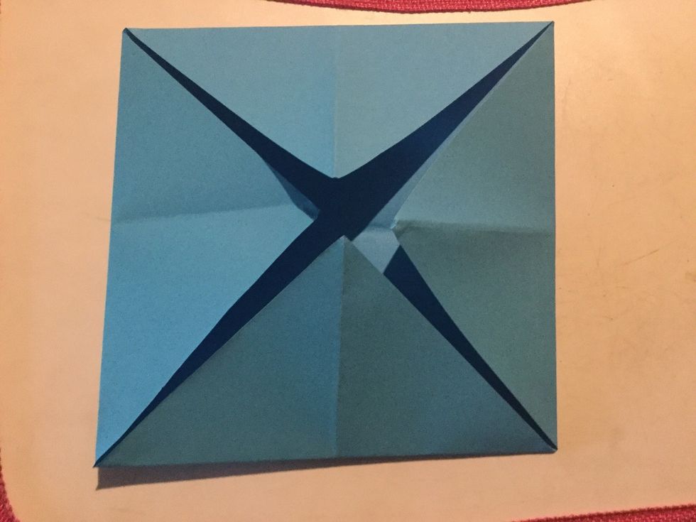 Step 4: Get all corners of the paper (one at a time) and fold into the middle.