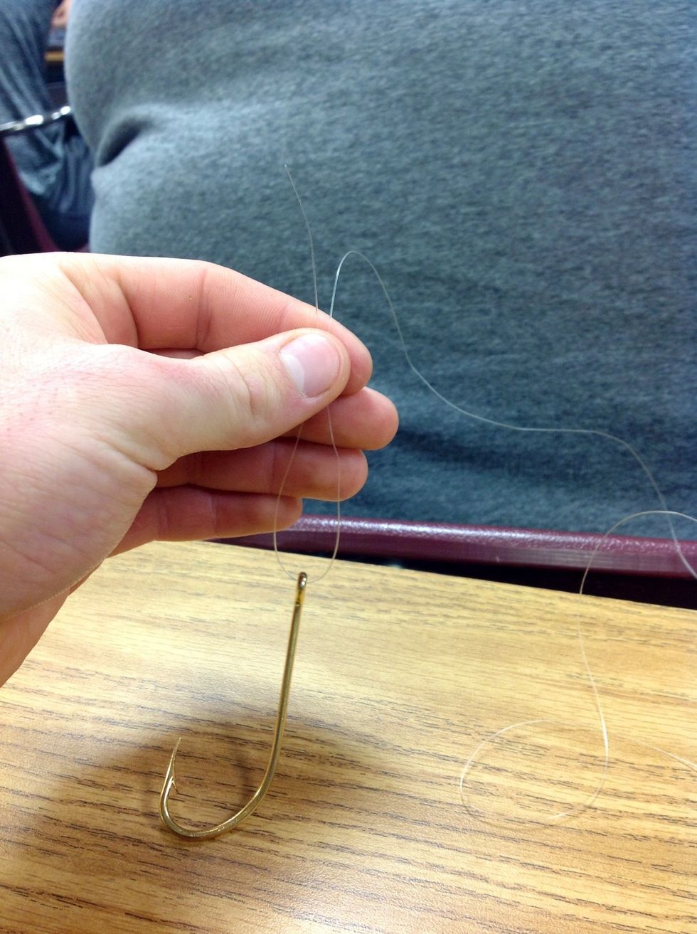 Step 4: Grab the end of the fishing line that you put through the eye of the hook and pull it up towards the other line 3 inches