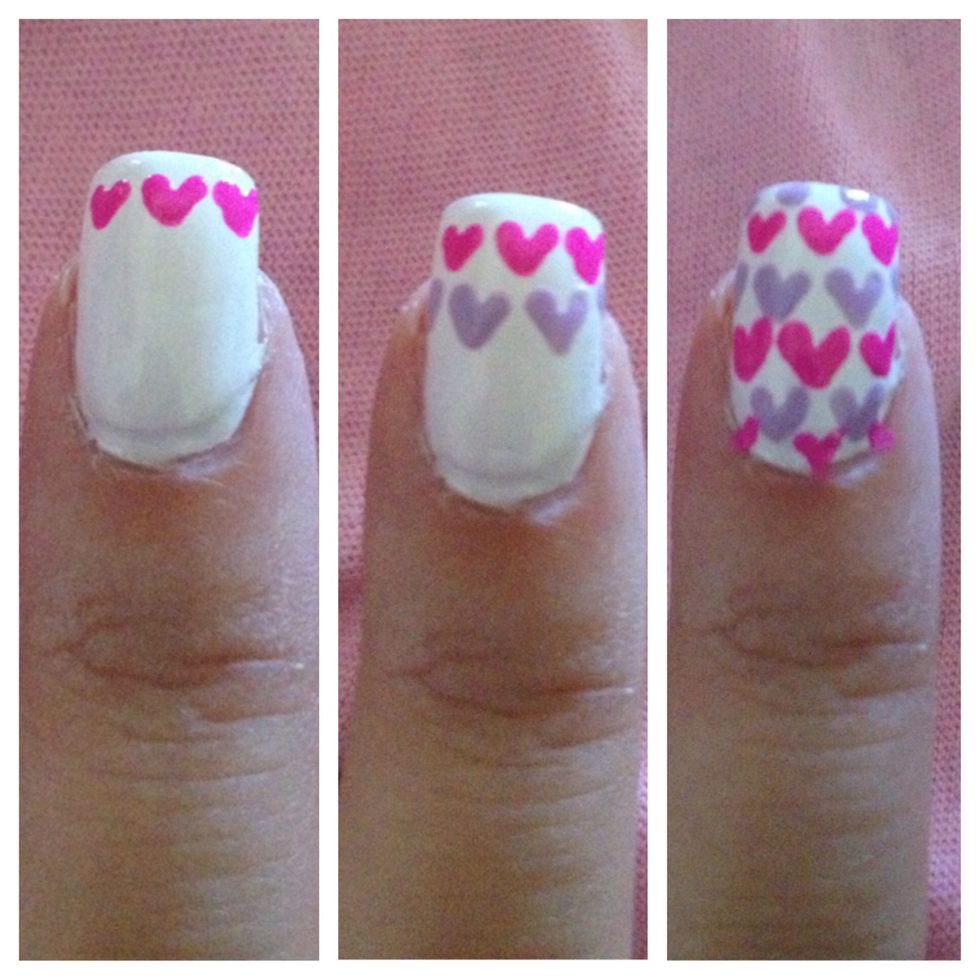 Step 4: On pointer finger, Create alternating rows of Pink and Purple Hearts. To do this, create v-shapes with dotting tool. Let dry.