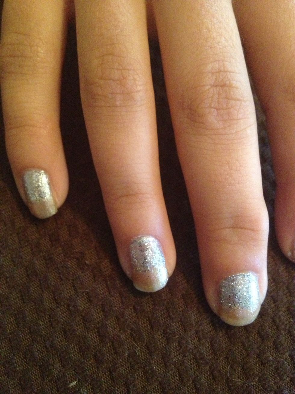 Step 4: Once base coat is dry, paint two coats on bottom half of nail with silver glitter nail polish
