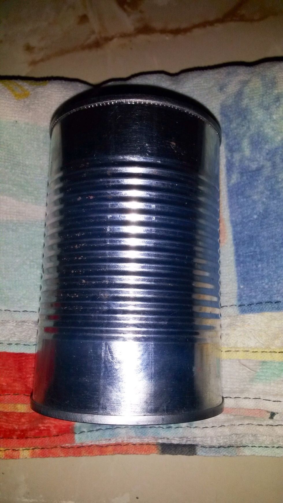Step 4: Once fully frozen, take the can out and dry it off so it's easier to work with. Place it on a towel to prepare it for hammering.