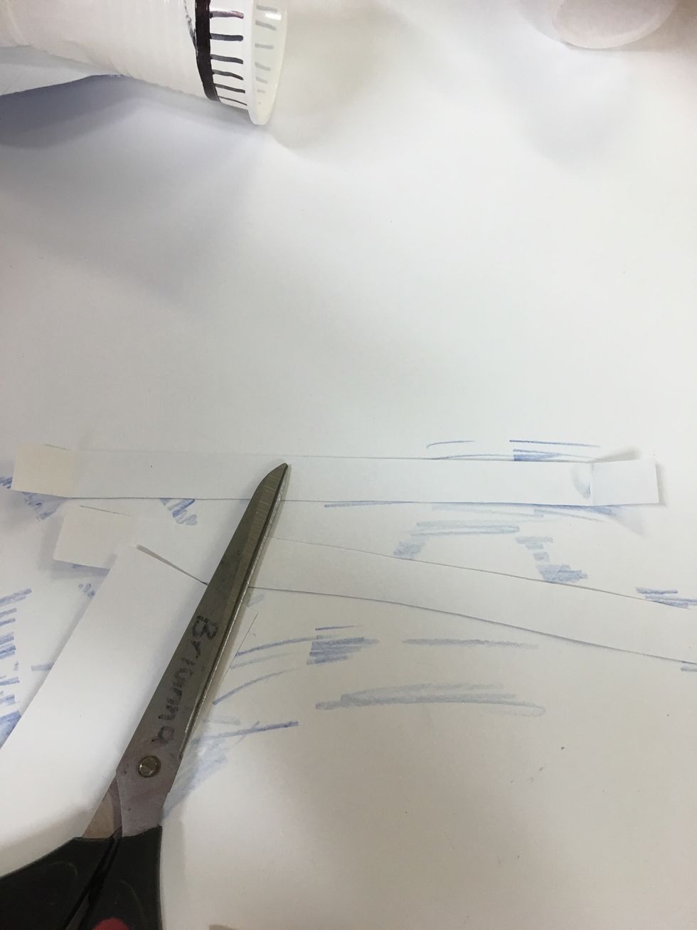 Step 4- Using the same card board, cut out two even strips of card board, they will be used as handle's for the trophy.