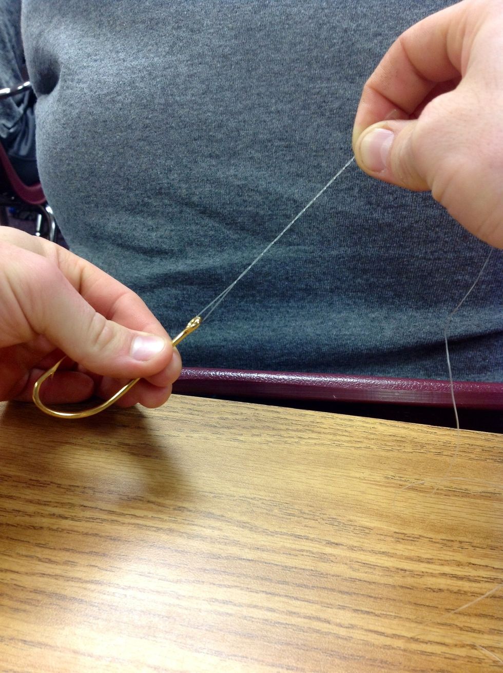 Step 5: Holding both lines in your right hand and the hook in your left hand twist the hook 5 to 6 times