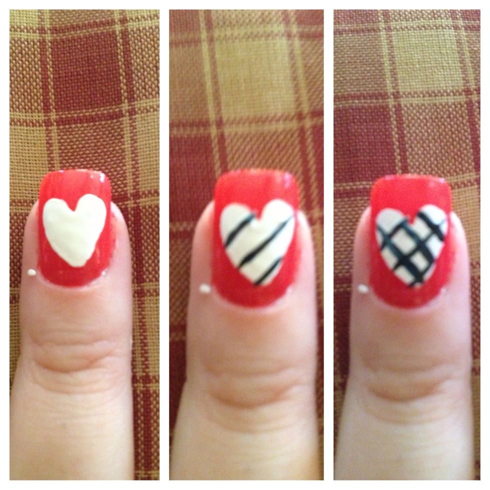 Step 5 (Middle Finger): Create heart with white acrylic paint and dotting tool. Next, use stripper brush and navy nail polish to create a crisscross pattern on top of heart