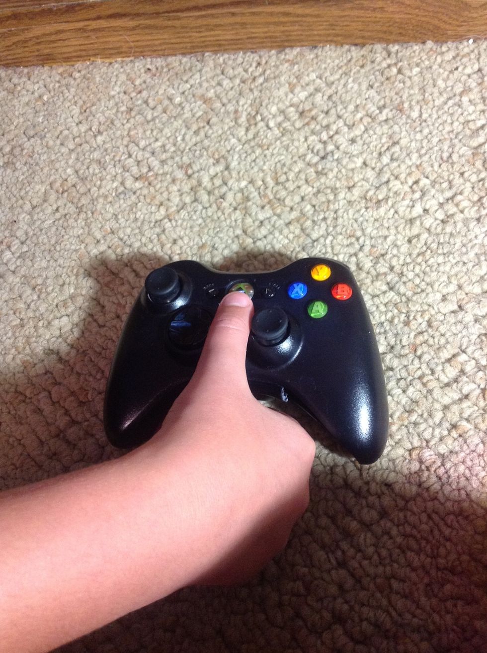 Step 5: Press and hold the middle button to turn on the controller.