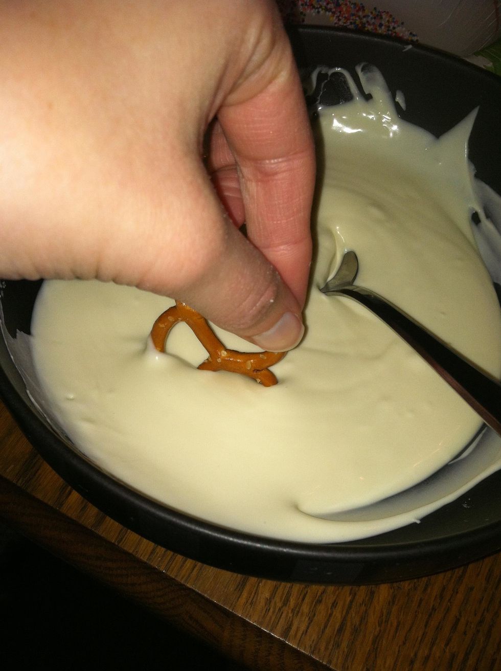 Step 6: Dip the pretzel in the chocolate half way.