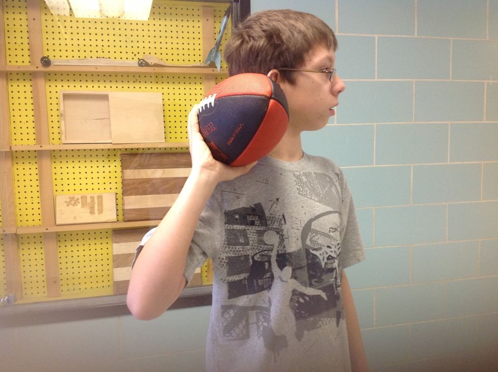 Step 6 Holding the ball in your dominate hand bring it back to your ear with your elbow bent.