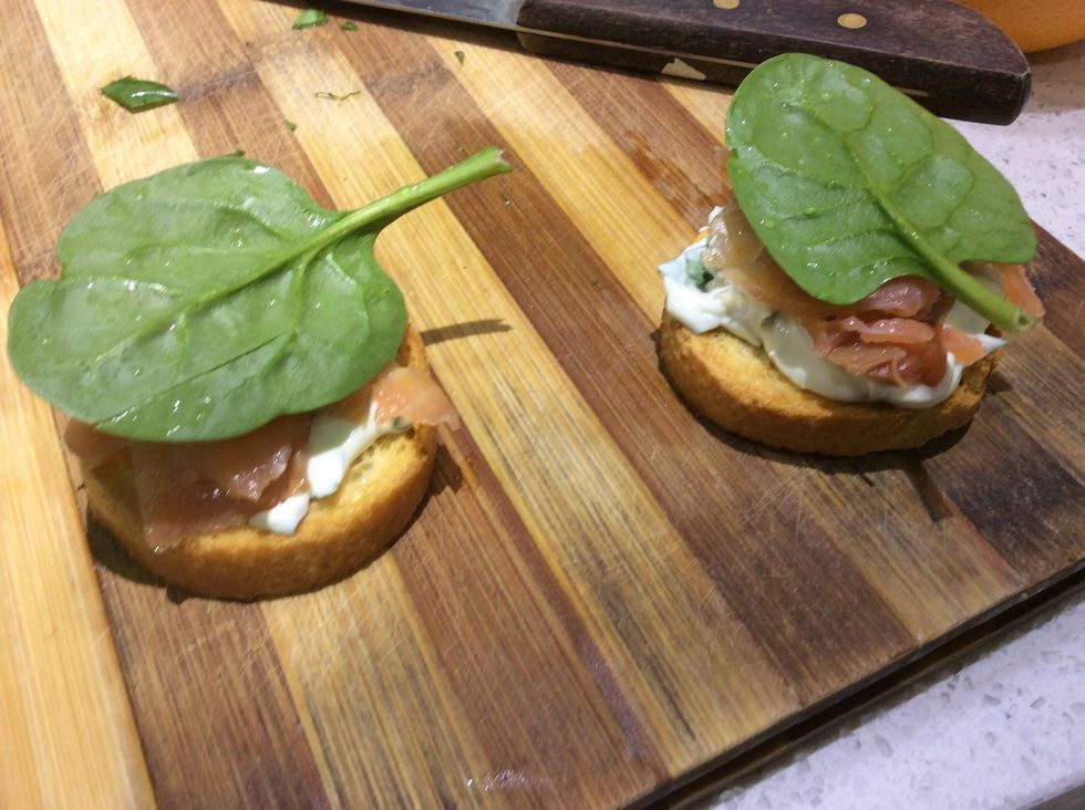Step 6: Once done, place the mixture on the bread then top it with salmon then a basil leaf to serve