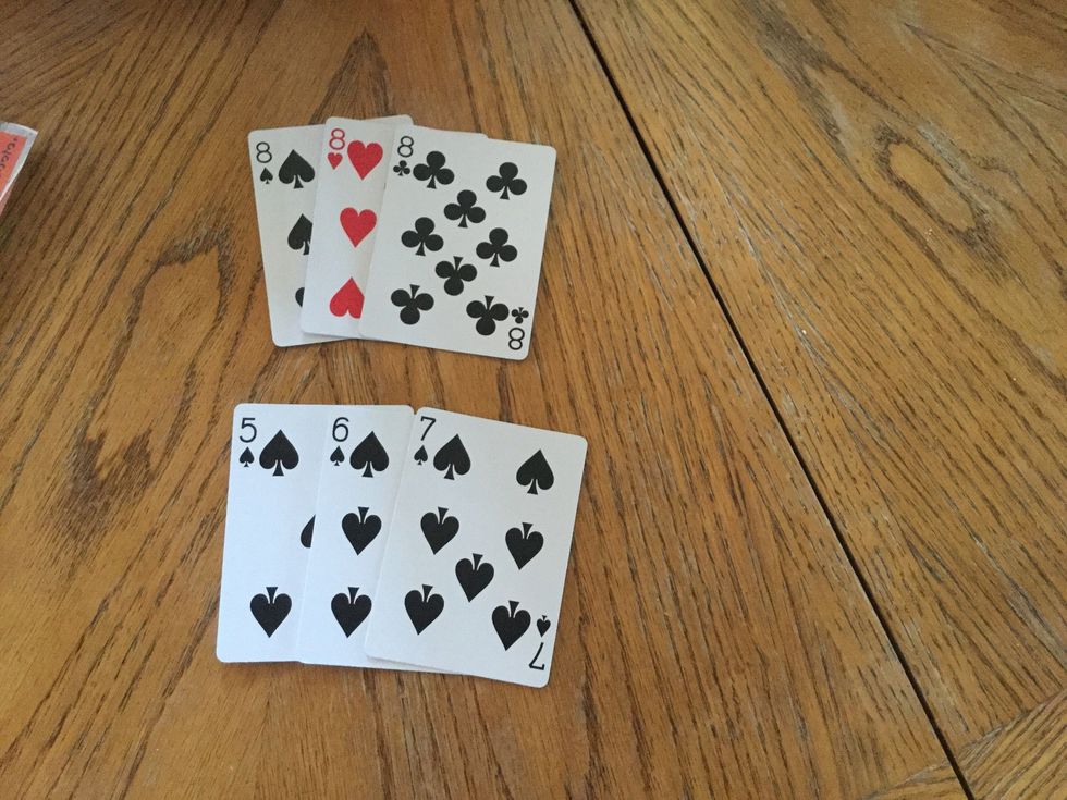 Step 6: The minimum of cards you can lay down is 3 so if you have 3 8\u2019s you can lay them down. If you have a run like of 5,6,7 they all have to be the same suit so like a 5,6,7 of spades.