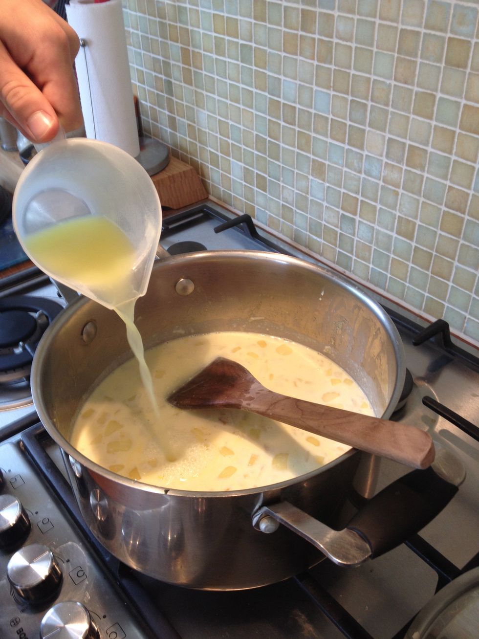 Step 6. Then ad the stock and the strained milk, make sure you have removed the bay leaf. Stirring it over a low heat for 1-2 minutes or until it thickens slightly.