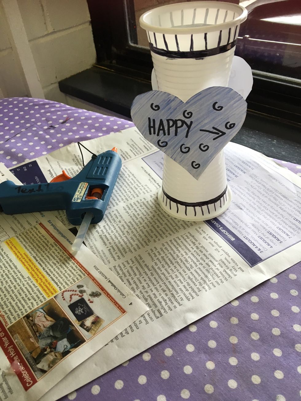 Step 6- Then glue the cups together and then glue the shapes onto the cups.