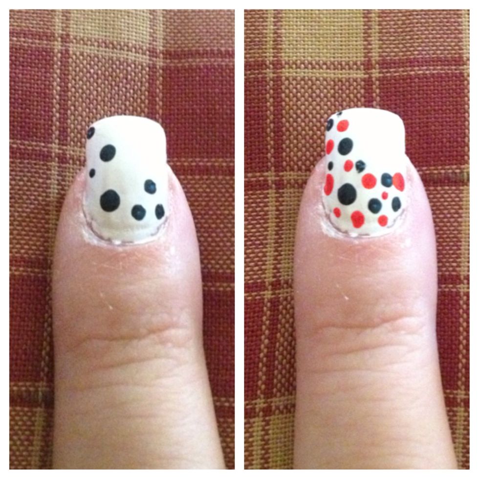Step 6: Use different sized dotting tools and Navy and red nail polishes to create a dotted pattern on bottom corner of nail