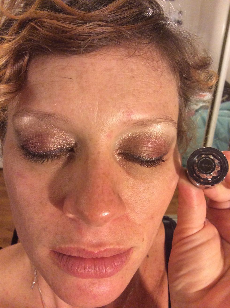 Step 6: Using Younique's eye liner brush, apply Younique's shimmer pigment Devious mixed with Younique's Rose Water to the top lash line