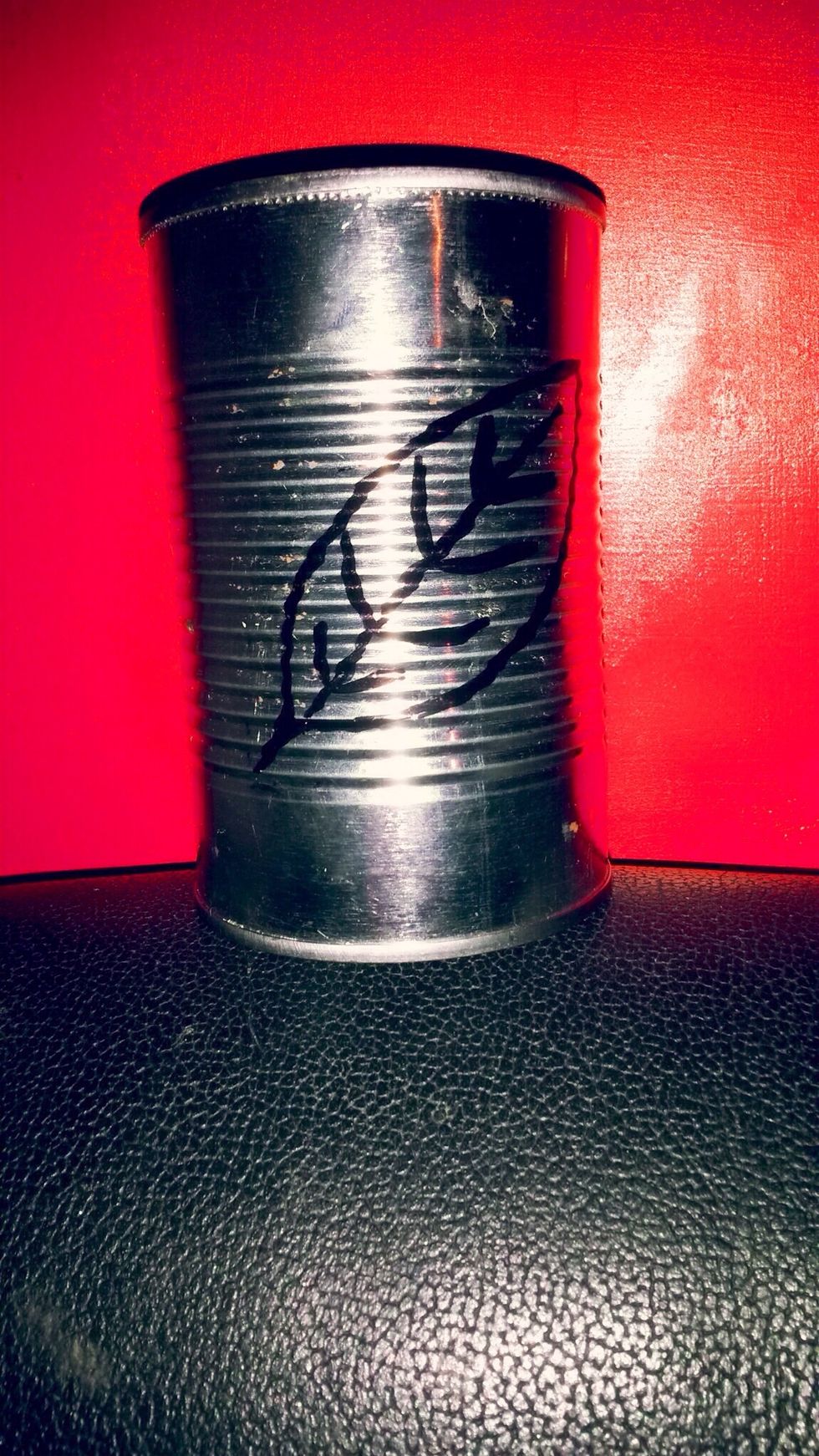 Step 6: You can tape a picture of your choice on the can or you can draw one. For my design, I chose a leaf.