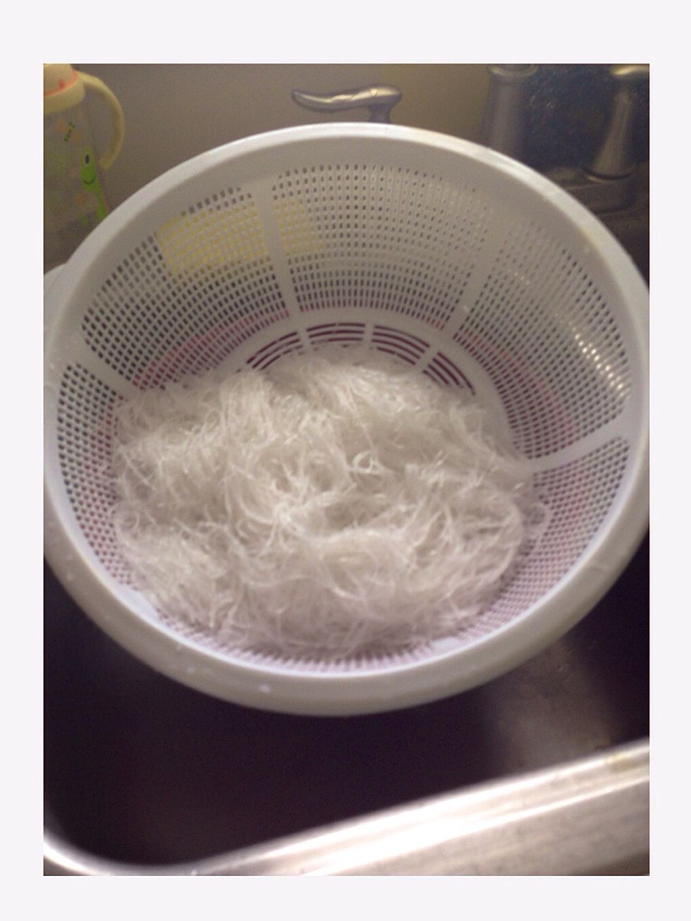 Step 7: After 5 minutes, drain the water out of the bean threads.