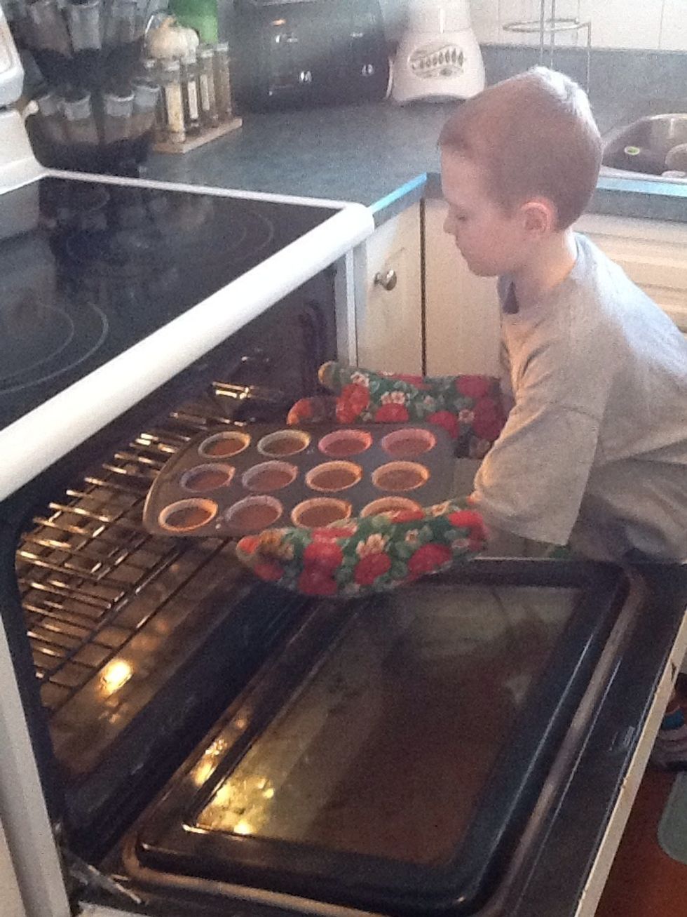 Step 7. Put the cupcakes in the oven. Safety tip. Make sure to wear oven mitts.
