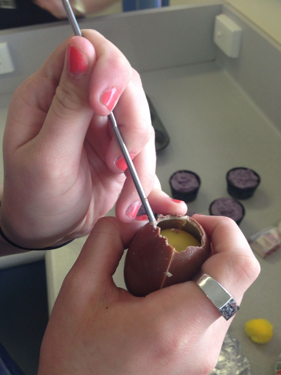 Step 7. With a metal skewers remove the top of the egg, making sure they don't break. Leave the surprise or toy in the middle it is a lot easier to work around.