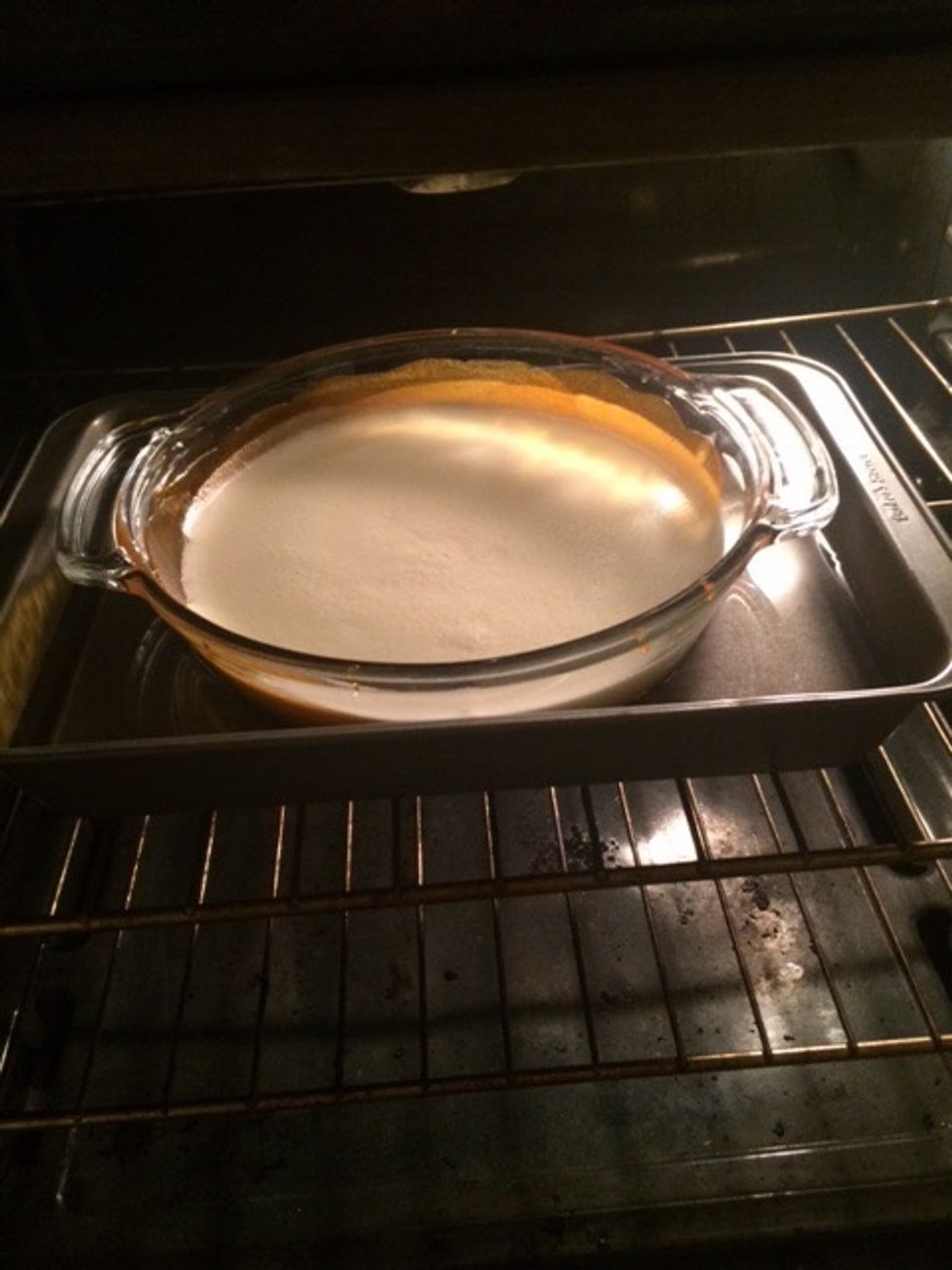 Step 8 - 1 hour: Carefully put the baking pan with water and round baking dish with flan mixture into the oven and bake for 1 hr.