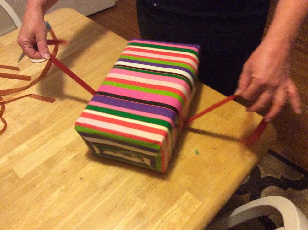 Step 8: Get your ribbon and pull it out from under your present.