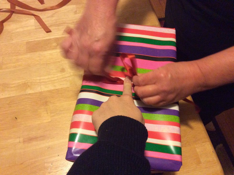 Step 9: Get someone to hold a finger down when trying to tie the bow so your ribbon will stay put.