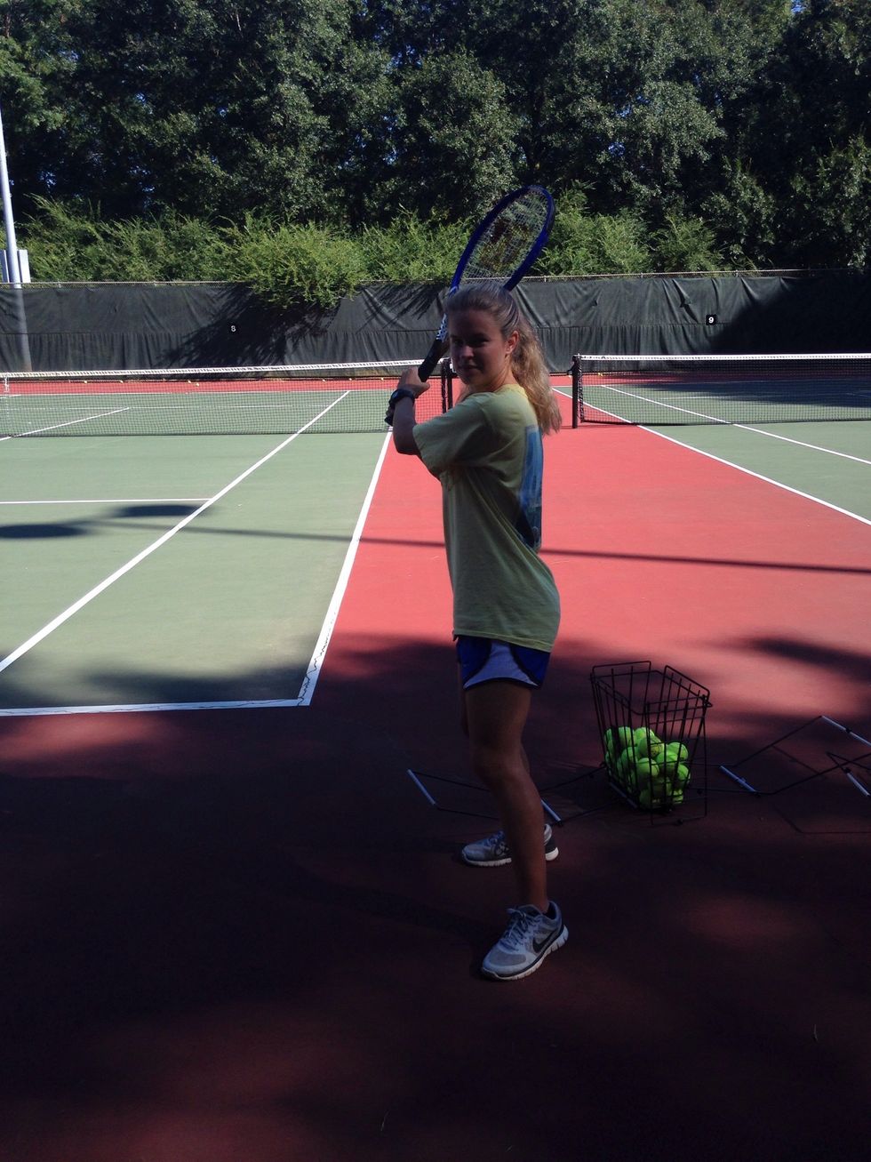 Step back and put less dominant leg out ready to hit the ball.