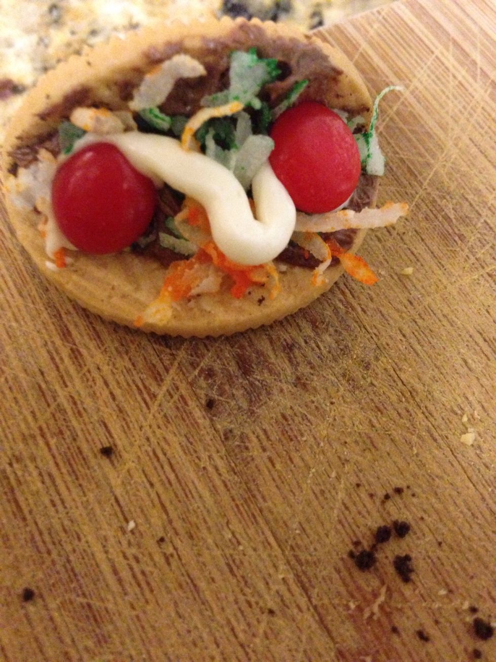 Step eight: Put two red hots on both sides of the taco