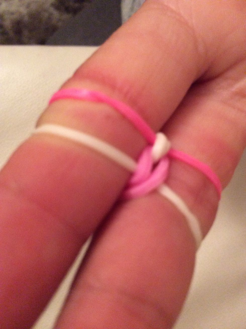 Step five, at last take the bottom again and put it on top of the other rubber bands.