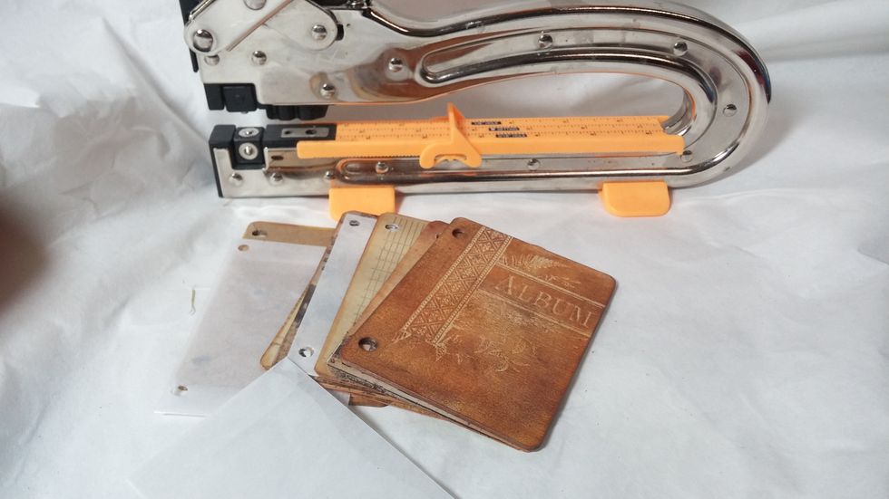 Step Five: Use a punch to make holes in your pages for binding. I also included some envelopes in my book.