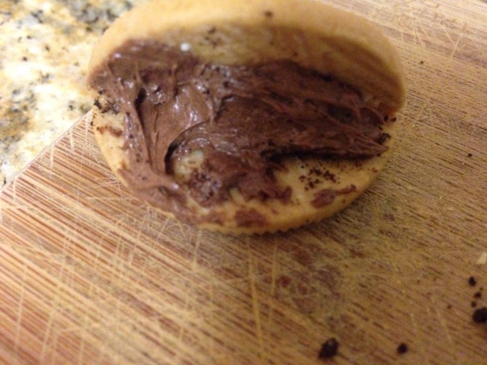 Step four: Get the chocolate frosting then put it on top of Oreo crumbs