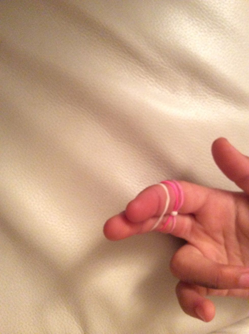 Step four, then get one more rubber band and put it on top of the others.