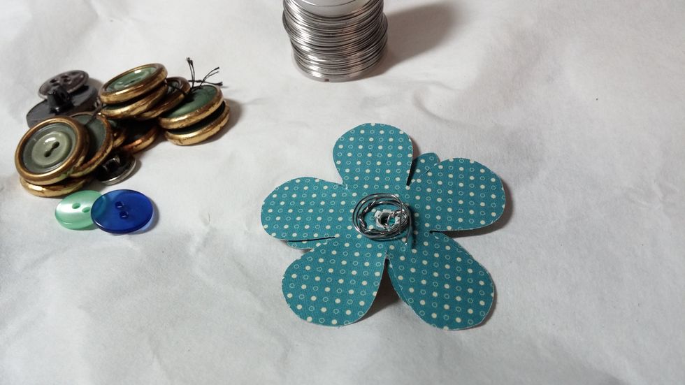 Step four: twist and curl the wire so the button stays in place.